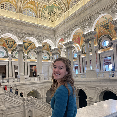 Maddie smiles and looks back at the camera with the Library of Congress in the background. Click to enlarge.