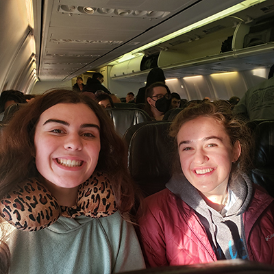 Kellie and Maddie smile for a selfie on the airplane. Click to enlarge.