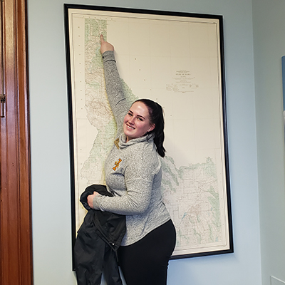 Victoria is pointing to Moscow on a large map of Idaho, while smiling at the camera. Click to enlarge.