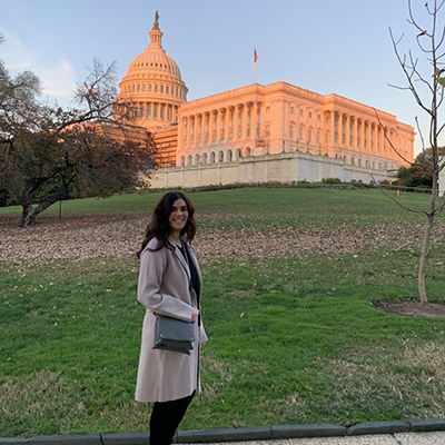 Kellie smiles for the camera with the Capitol Buildling behind her at sunset. Click to enlarge.
