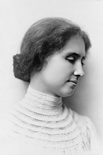 This is a profile picture of Helen Keller. She is looking off to the side with her eyes closed. She has a slight smile and her hair is tied into a bun. She is wearing a high collared white dress.
