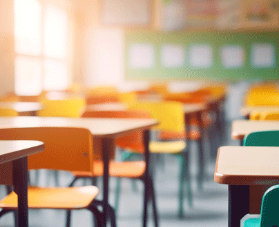 An school classroom with rows of empty desks.