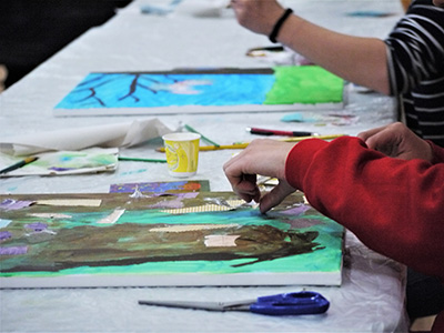 A close-up of two participants working on their art.